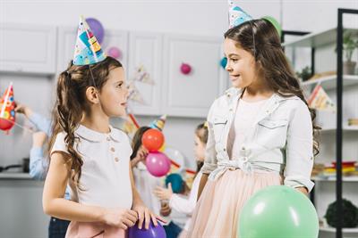 two-girls-looking-each-other-while-celebrating-birthday-kitchen.jpg